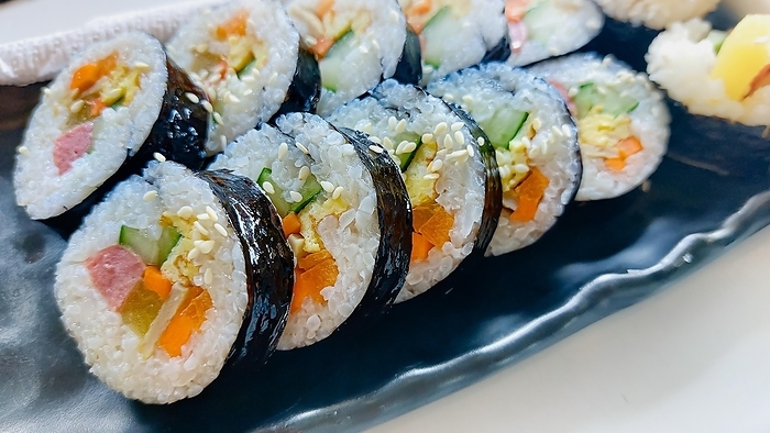 Close up of a Kimbap served in a black long plate, South Korean food, by MartinxMarie