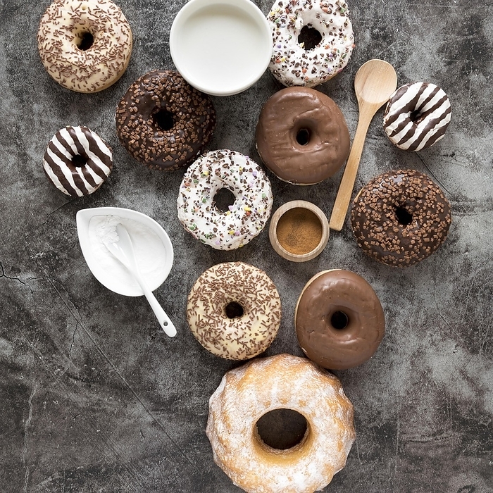Top view variety donuts with milk powdered sugar, by Oleksandr Latkun