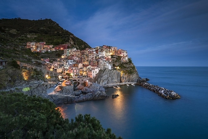 Village view, Colourful houses of the fishing village of Manarola, Evening atmosphere, Cinque Terre National Park, Liguria, Italy, Europe, by Robert Haasmann