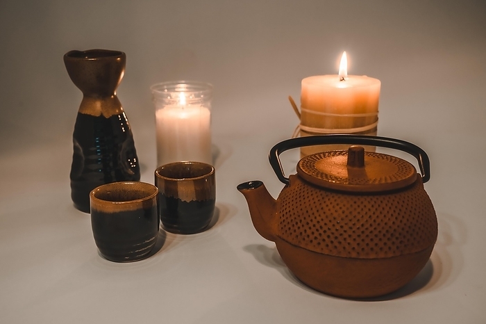Japanese tea with beautiful candlelight and a Japanese cup and glasses, by Unai Huizi