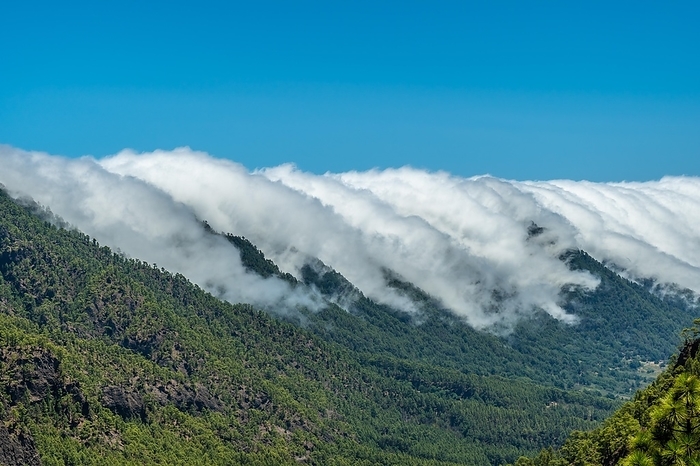 Clouds cross the mountains from side to side on the island of La Palma, Canary Islands. Spain, by Unai Huizi