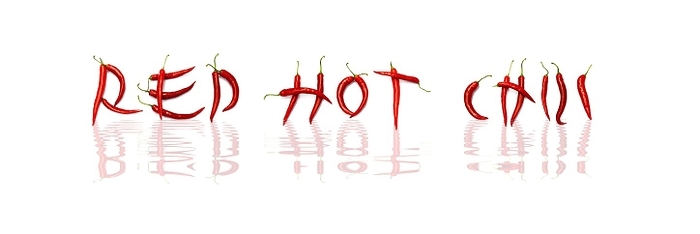 Red chilli peppers arranged to spell out RED HOT CHILI . The chillies are against a white background, by fotoping