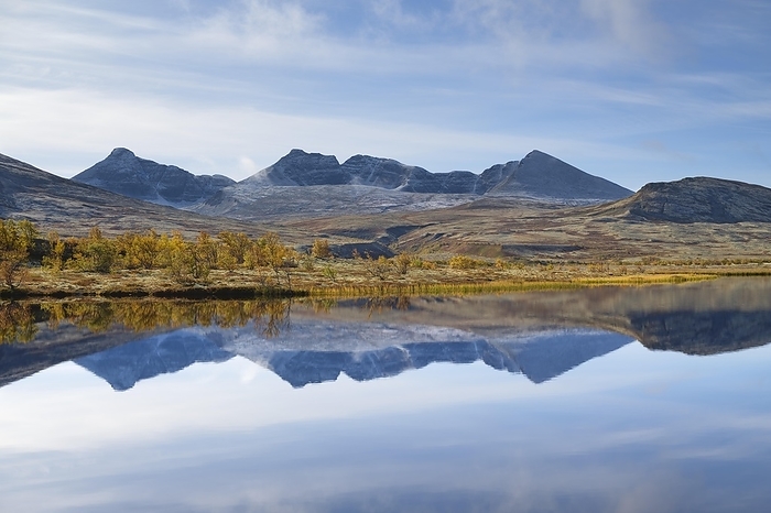 The mountains Høgronden and Digerronden reflected in the water of a lake, autumn in Døralen, Rondane National Park, Innlandet, Oppland, Norway, Europe, by Susanne Aigner