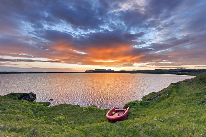 Iceland Red rowboat, plastic rowing boat on the shore of lake Presth lal n at sunset, coastal sea lagoon near K pasker in summer, Nor urland eystra, Iceland, Europe, by alimdi   Arterra   Sven Erik Arndt