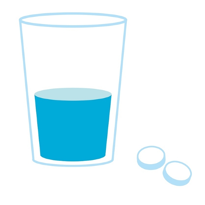 Tablets and a glass of water