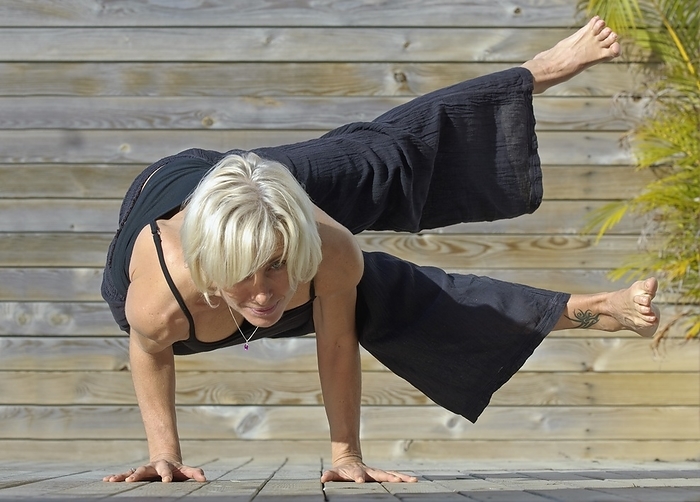 Mature Woman In Yoga Position, by Ben Welsh / Design Pics
