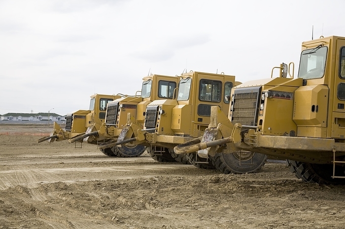 Row Of Construction Loaders, by LJM Photo / Design Pics