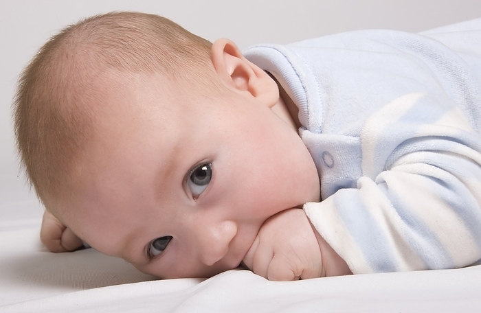 Close-Up Of Baby Lying Down, by John Short / Design Pics