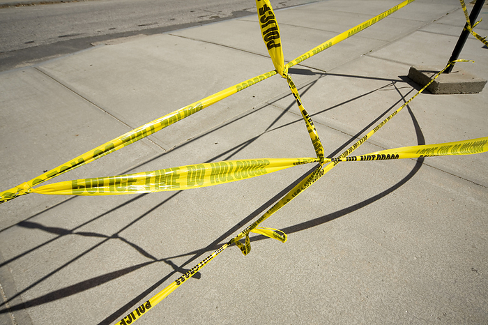 Yellow Caution Tape Reading Police Line - Do Not Cross Strung Across Sidewalk, by Peter Glass / Design Pics
