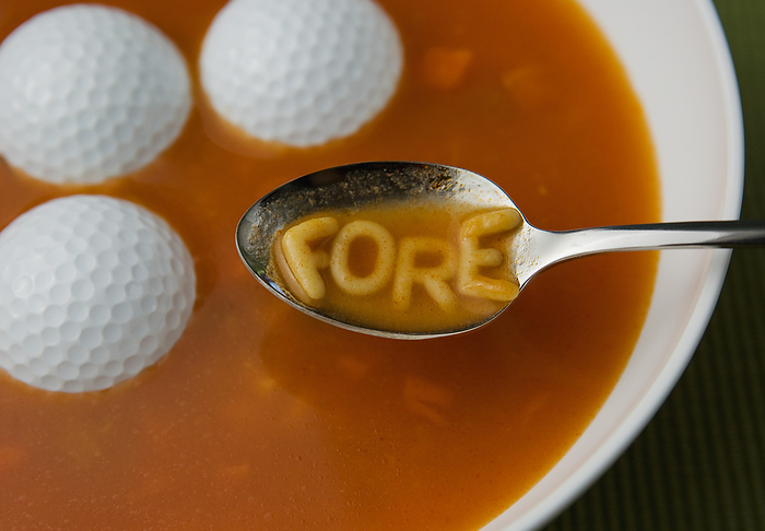 Golf Balls In Soup With The Word Fore Spelled Out In Alphabet Noodles On Spoon, by Kate Williams / Design Pics