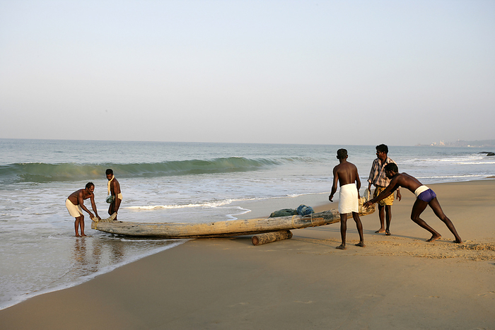 India Fishermen Pushing Their Boat From The Beach Into The Water  Kovalam, Kerala, India, by Chris Caldicott   Design Pics