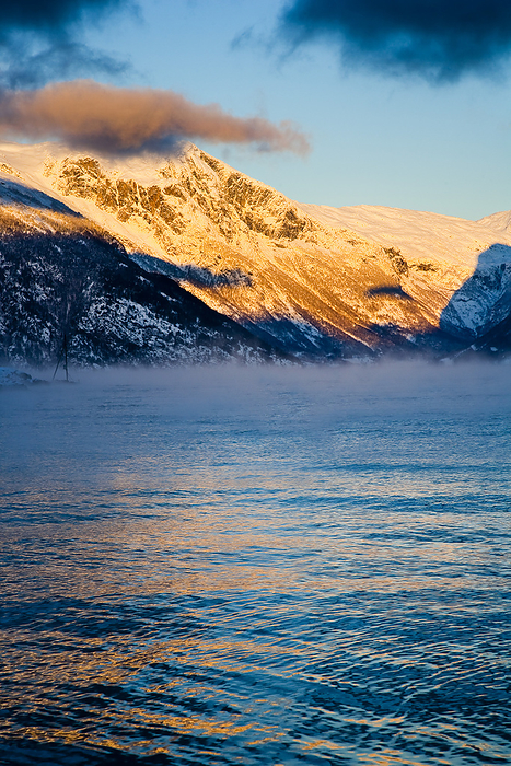 Norway Snow Covered Mountains Illuminated By Golden Sunlight At Sunset  Ortnevik, Sognefjord, Norway, by Naki Kouyioumtzis   Design Pics