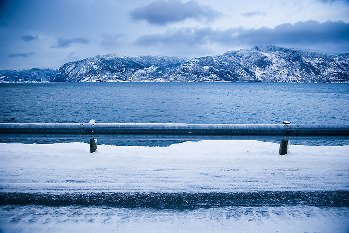 Norway Treacherous Icy Road Winding Around The Mountainside And Fjord Shoreline With Dramatic View Of The Mountains  Ortnevik, Sognefjord, Norway, by Naki Kouyioumtzis   Design Pics