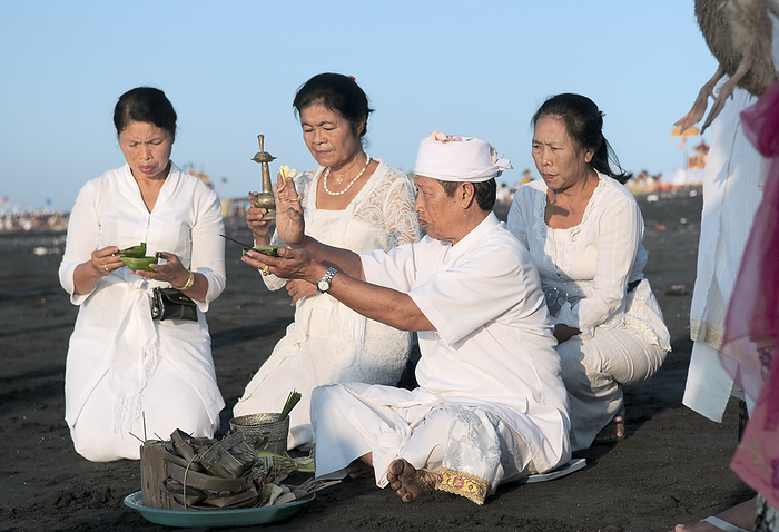 Indonesia Bali Island Family And Priest Making An Offering At The Melasti Festival To Honor The Gods Of The Sea  Bali, Indonesia, by Elena Roman Durante   Design Pics