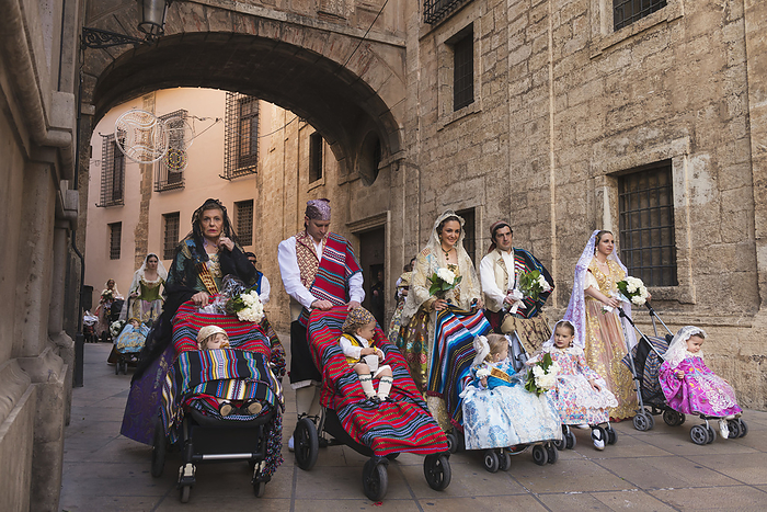 Valencia, Spain Parents With Babies In Pushchairs Dressed Up In Traditional Casal Faller Outfits With Flower Offering For Virgin De Los Desamparados At Fallas Festival  Valencia, Spain, by Ian Cumming   Design Pics