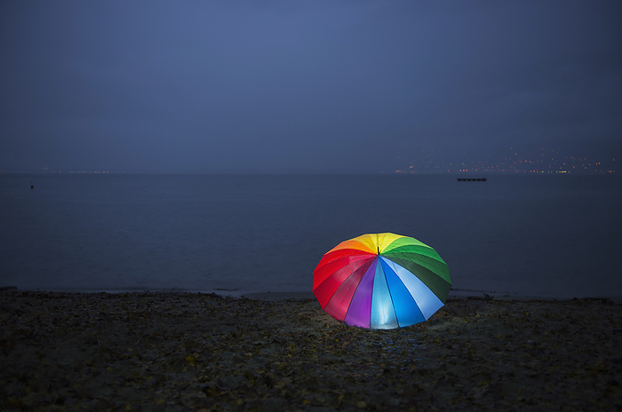 Switzerland A Colourful Rainbow Umbrella Illuminated On The Shore Of Lake Maggiore At Nighttime  Locarno, Ticino, Switzerland, by Mats Silvan   Design Pics