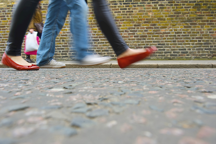 London, United Kingdom Pedestrians Walking On A Sidewalk Of Portobello Road Beside A Brick Building  London, England, by Ingrid Rasmussen   Design Pics
