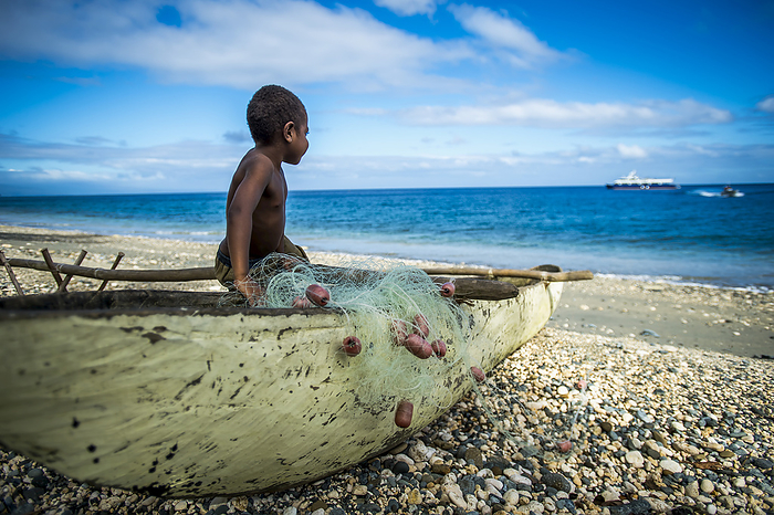 Vanuatu A Young Boy Watching A Cruise Ship Arrive  Pentecost Island, Vanuatu, by David Kirkland   Design Pics