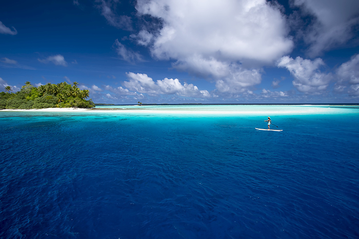 Paddle Boarding By A Remote Atoll Of The Marshall Islands; Marshall Islands, by David Kirkland / Design Pics