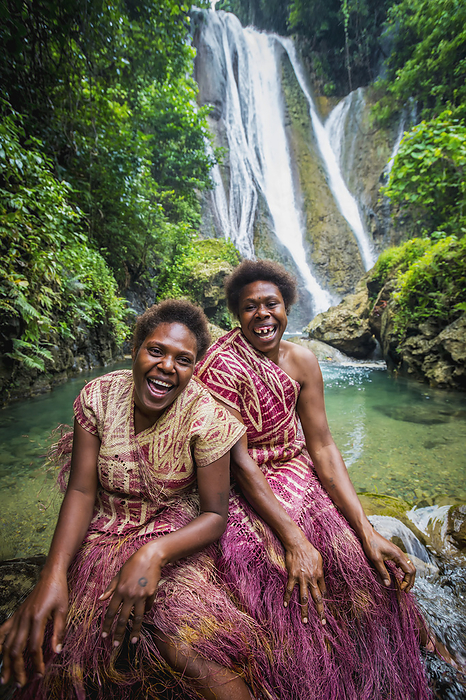 Vanuatu A Waterfall On Tanna Island With Two Women In Traditional Costume In The Foreground  Tanna Island, Vanuatu, by David Kirkland   Design Pics