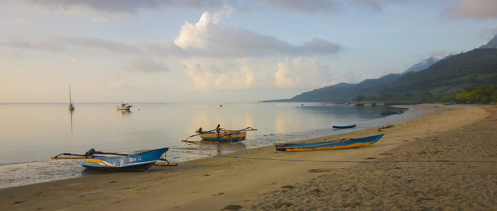Tranquil Ocean At Sunrise With Boats On The Beach; Atauro Island, Timor-Leste, by David Kirkland / Design Pics