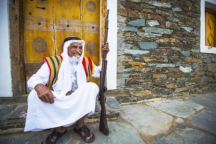 Saudi Arabia Elderly Man And Musket Relaxing, Near Rijal Alma Village  Asir Province, Saudi Arabia, by David Kirkland   Design Pics