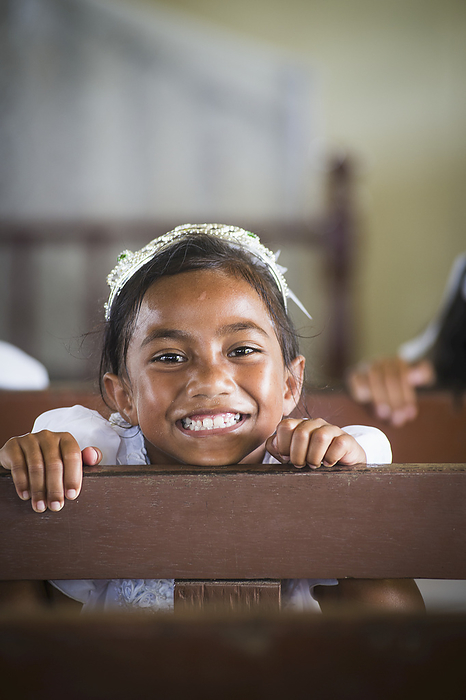 Young Girl On Wooden Bench In Church On Hapai Island; Tonga, by David Kirkland / Design Pics