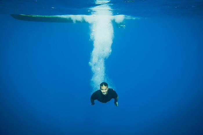 Tongan Swimmer Diving Off A Boat; Vavau, Tonga, by David Kirkland / Design Pics