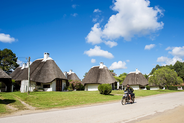 Uruguay Cycling Down A Road With Traditional Houses  La Pedrera, Uruguay, by Dosfotos   Design Pics