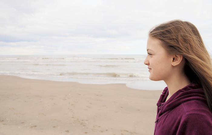 Girl Standing On Beach; Toronto, Ontario, Canada, by Vast Photography / Design Pics