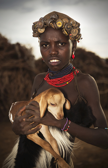 Ethiopia A Young Tribal Woman Holding A Baby Goat, Omo Valley  Ethiopia, by Marg Wood   Design Pics