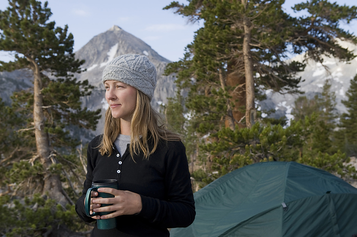 America Woman drinks coffee at a campsite at Sixty Lake Basin in Kings Canyon National Park  California, United States of America, by Joel Sartore Photography   Design Pics