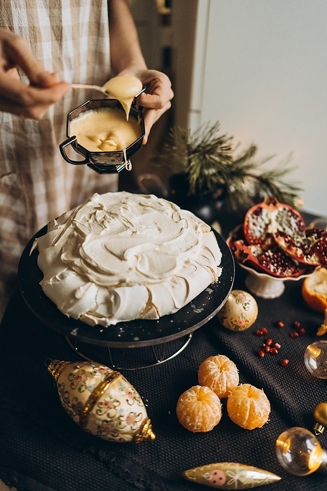 Woman baking Christmas and New Year cake, by Cavan Images / Vetrana