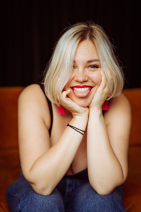 Charming smiling happy blonde woman, red lipstick, close-up portrait., by Cavan Images / Yuliya Kirayonak