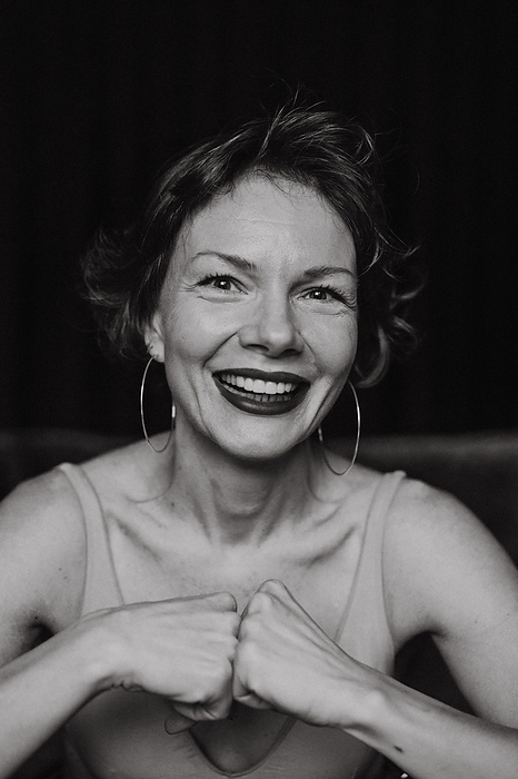 Smiling woman with short hair, black and white emotional portrait., by Cavan Images / Yuliya Kirayonak