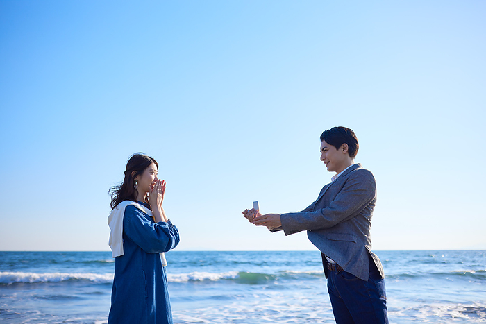 Japanese man proposing by the sea
