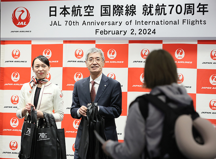 Japan Airlies  JAL  celebrates the company s 70th anniversary of international flights February 2, 2024, Tokyo, Japan   Japan Airlines  JAL  president Yuji Akasaka gives away small gifts to passengers to celebrate for the company s 70th anniversary of international flights before the commemoration flight bound for Honolulu, Hawaii at the Haneda airport in Tokyo on Friday, February 2, 2024.    photo by Yoshio Tsunoda AFLO 