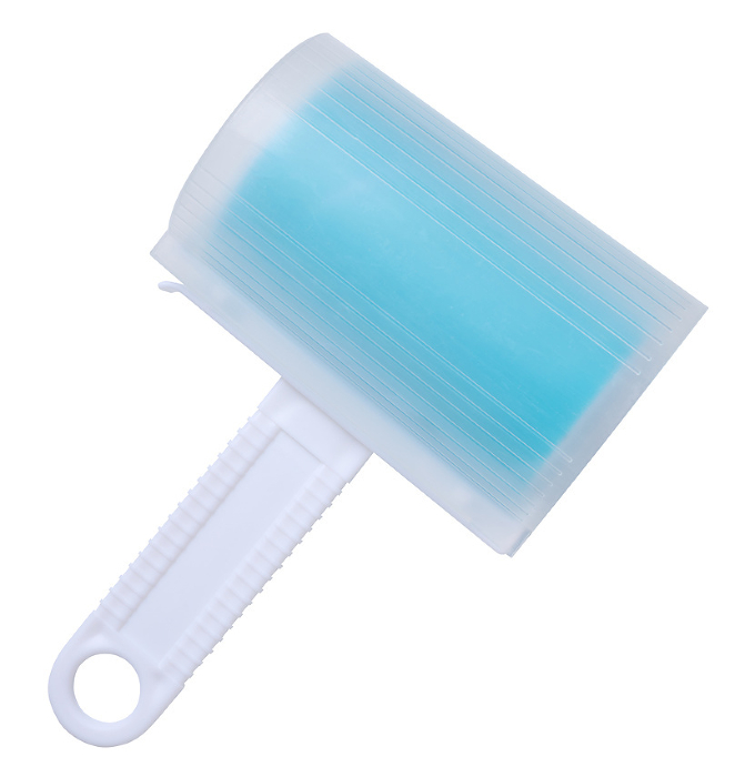 Roller with sticky tape for cleaning clothes on a white background, top view Roller with sticky tape for cleaning clothes on a white background, top view