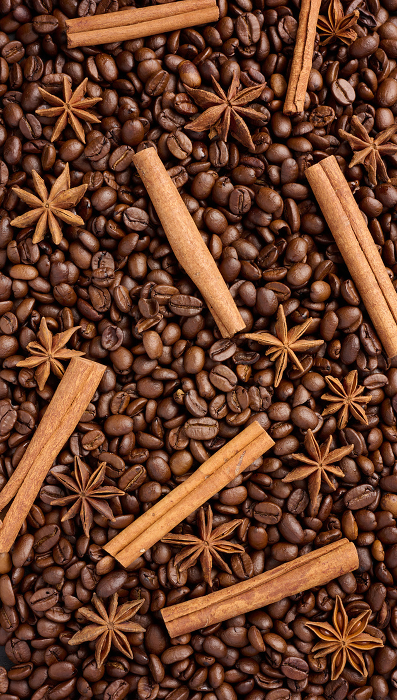 Roasted coffee beans, cinnamon sticks and star anise, full frame Roasted coffee beans, cinnamon sticks and star anise, full frame