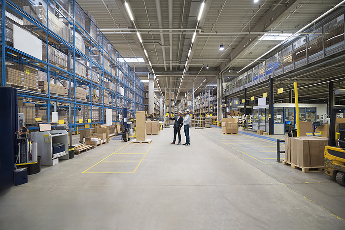 Businessmen having discussion in warehouse