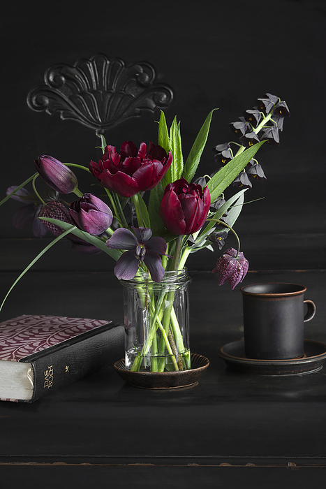 Freshly picked tulips, snakes head fritillaries (Frittilaria meleagris), Persian lilies (Frittilaria persica) and hellebores