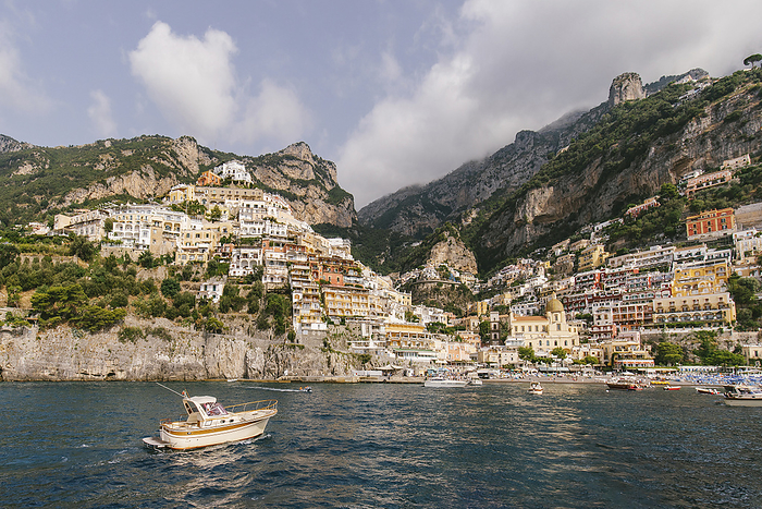 Positano view from sea Italy, Campania, Positano, Hillside village on Amalfi Coast with motorboat in foreground