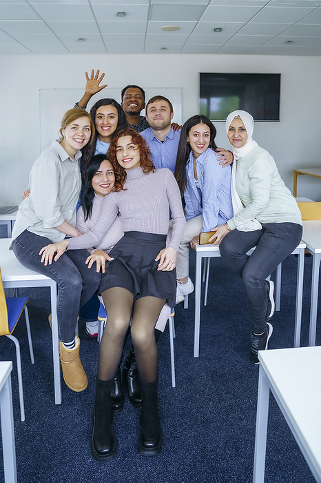 Multi-ethnic smiling students in training class at classroom