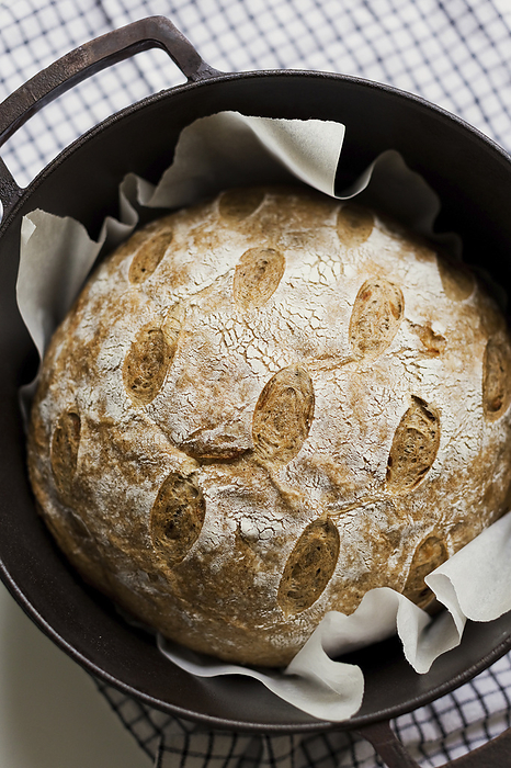 Freshly baked sourdough bread in cast iron cooking pan