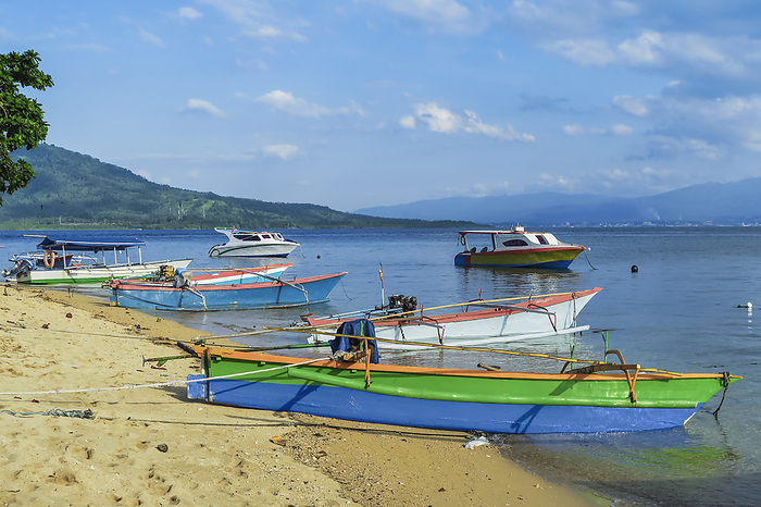 Outrigger canoes   launches at this coral fringed holiday island   scuba diving destination. Bunaken, North Sulawesi, Indonesia Outrigger canoes and launches at this coral fringed holiday island and scuba diving destination, Bunaken Island, Sulawesi, Indonesia, Southeast Asia, Asia, by Robert Francis