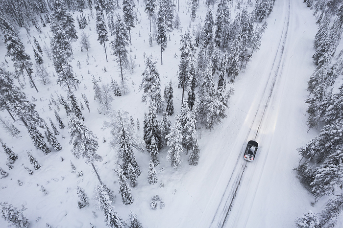 Aerial view of a car driving through the snow coverd forest on icy road, Akaslompolo, Finnish Lapland, Finland, Scandinavia, Europe Aerial view of a car driving through the snow covered forest on icy road, Akaslompolo, Finnish Lapland, Finland, Scandinavia, Europe, by Paolo Graziosi