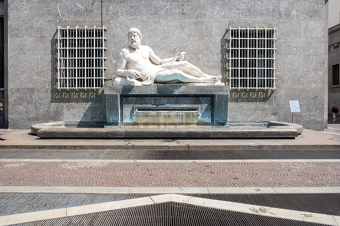 View of the Fountain of Po in Turin s Via Roma, Piedmont, Italy. Executed by Umberto Baglioni  1893 1965  and placed in 1939, the allegorical statue represents the river Po with a man lying on a pedestal, from which water flows. View of the Fountain of Po in Via Roma, executed by Umberto Baglioni, 1893 1965, and placed in 1939, the allegorical statue represents the River Po with a man lying on a pedestal, from which water flows, Turin, Piedmont, Italy, Europe, by MLTZ