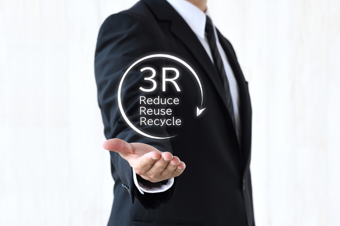 Businessman's hand holding up the 3R logo