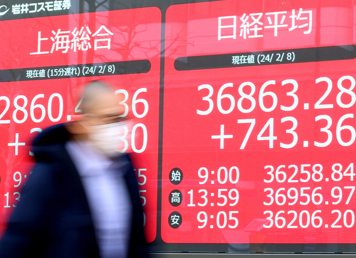 Jaoan s share prices closed a 34 year high of 36,863.28 yen t the TSE February 8, 2024, Tokyo, Japan   A pedestrian passes before a share prices board in Tokyo on Thursday, February 8, 2024. Japan s share prices rose 743.36 yen to close at 36,863.28 yen of a 34 year high at the Tokyo Stock Exchange.     photo by Yoshio Tsunoda AFLO 