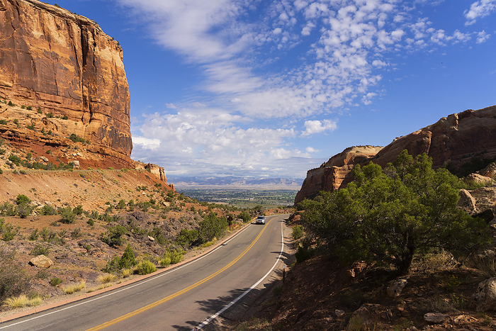 The road that travels through the landscape of Colorado National Monument near Grand Junction, Colorado. It is an amazing place of red rock and a fine example of erosion at work; Colorado, United States of America, by Robert Postma / Design Pics